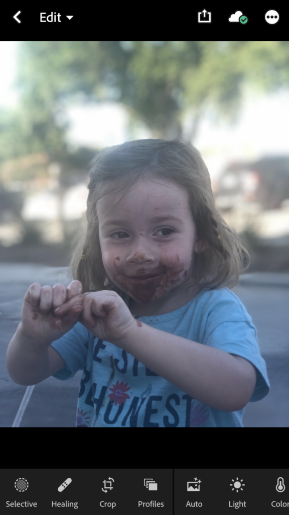 Little girl with chocolate ice cream on her face