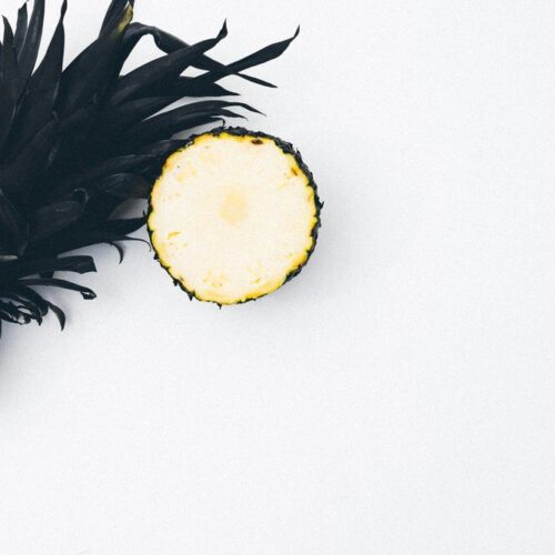 cut pineapplel on white table