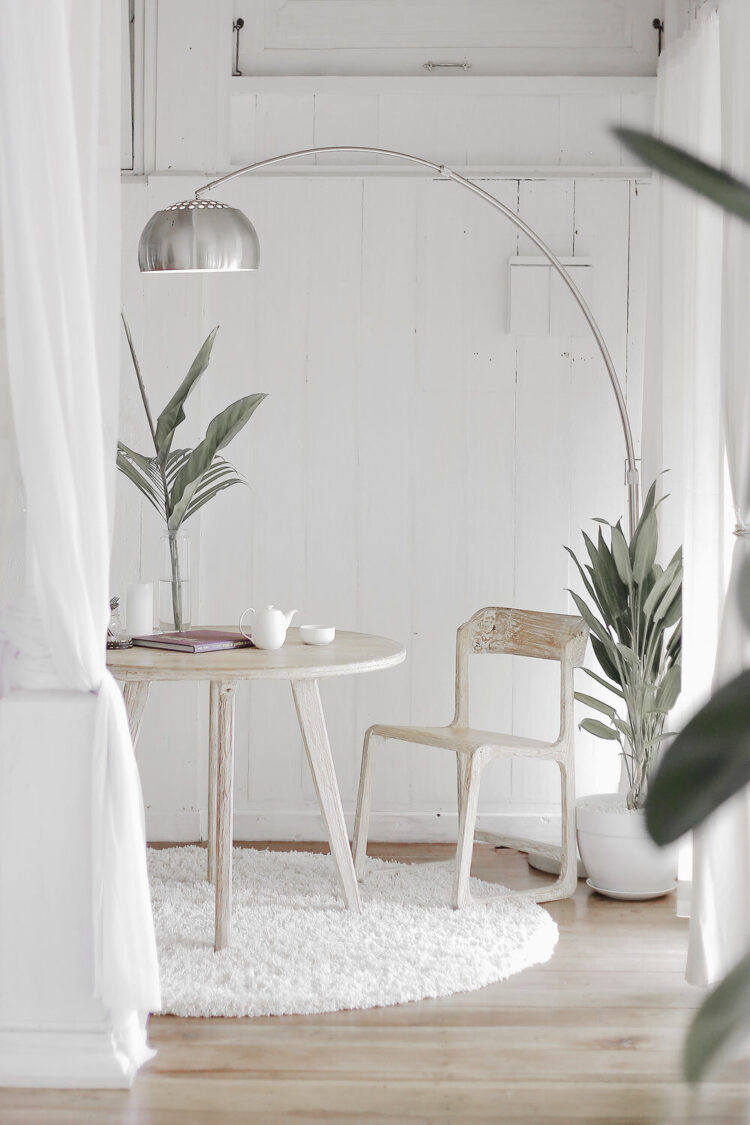 Natural color tables in white room with plants