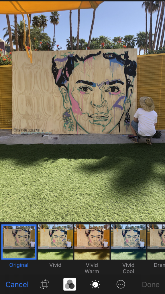 man painting mural of Frida Kahlo