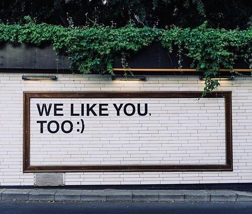 wall sign that says, we like you