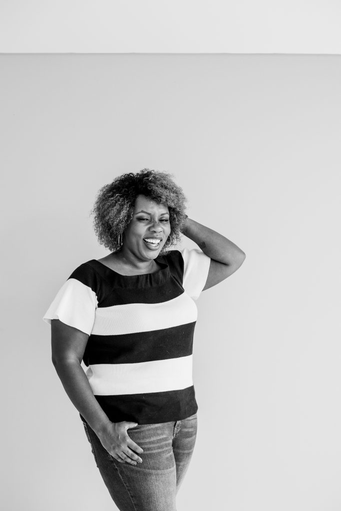 Black and white photo of Black woman laughing into the abyss